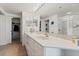 Bathroom featuring double sinks, plenty of vanity space, and tiled floors, offering style and functionality at 5300 S Atlantic Ave # 7-301, New Smyrna Beach, FL 32169