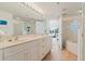 Bright bathroom with a dual-sink vanity, glass shower, and bathtub, creating a spa-like experience at 5300 S Atlantic Ave # 7-301, New Smyrna Beach, FL 32169
