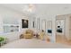 Bright bedroom with a large window, unique decor, comfortable armchair, and views into the hallway at 5300 S Atlantic Ave # 7-301, New Smyrna Beach, FL 32169