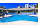 Outdoor community pool featuring a tanning deck, ample seating, and a charming open air cabana at 5300 S Atlantic Ave # 7-301, New Smyrna Beach, FL 32169