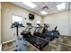 Well-equipped gym featuring treadmills, stationary bikes, and a wall-mounted television for entertainment at 5300 S Atlantic Ave # 7-301, New Smyrna Beach, FL 32169