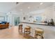 Open kitchen with barstool seating, granite counters and tile flooring, with a view of the living room and balcony at 5300 S Atlantic Ave # 7-301, New Smyrna Beach, FL 32169