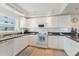 Bright kitchen featuring white cabinets, a double sink, and matching white appliances for a clean aesthetic at 5300 S Atlantic Ave # 7-301, New Smyrna Beach, FL 32169