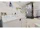 Functional laundry room with a washing machine, dryer, wire shelving, and a modern HVAC system at 5300 S Atlantic Ave # 7-301, New Smyrna Beach, FL 32169