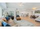 Open concept living room, featuring tile floors, comfortable seating, and access to balcony at 5300 S Atlantic Ave # 7-301, New Smyrna Beach, FL 32169