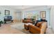 Bright living room features tile flooring, comfortable seating, and views of nearby residential buildings at 5300 S Atlantic Ave # 7-301, New Smyrna Beach, FL 32169