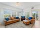 Bright living room boasts tile floors, neutral decor, and plush seating arrangements at 5300 S Atlantic Ave # 7-301, New Smyrna Beach, FL 32169