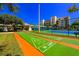 A recreational shuffleboard area, with a tennis court, landscaping and residential building in the background at 5300 S Atlantic Ave # 7-301, New Smyrna Beach, FL 32169