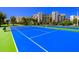 Brightly colored tennis court located within a meticulously maintained community with lush surroundings at 5300 S Atlantic Ave # 7-301, New Smyrna Beach, FL 32169