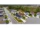 A neighborhood aerial view with a lush greenbelt with homes that feature solar panels and well-manicured lawns at 600 Bullrush Ct, Davenport, FL 33837