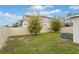 Backyard with green grass, a fence, and a small air conditioning unit at 600 Bullrush Ct, Davenport, FL 33837