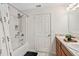 Bathroom with a bathtub and shower, a double vanity sink and cabinets, and white walls at 600 Bullrush Ct, Davenport, FL 33837