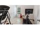 Exercise room featuring a stationary bike, weights, and a large window for natural light at 600 Bullrush Ct, Davenport, FL 33837