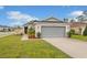 Charming single-story home with a well-manicured lawn and a spacious two-car garage at 600 Bullrush Ct, Davenport, FL 33837