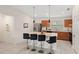 Open kitchen features stainless steel appliances, modern pendant lighting, and granite countertops at 600 Bullrush Ct, Davenport, FL 33837