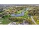 Beautiful aerial view of golf course with scenic water feature and lush green landscaping at 6339 Coopers Green Ct, Orlando, FL 32819
