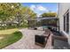 Landscaped backyard featuring a screened-in pool area and a paved patio with comfortable outdoor seating at 6339 Coopers Green Ct, Orlando, FL 32819