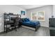 Cozy bedroom featuring a bed, workstation, and a window bringing in natural light at 6339 Coopers Green Ct, Orlando, FL 32819