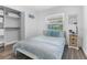 Cozy bedroom with a queen bed, closet, and natural light from the window at 6339 Coopers Green Ct, Orlando, FL 32819