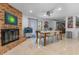 Open dining area featuring a brick fireplace, tile floors, and easy access to the kitchen at 6339 Coopers Green Ct, Orlando, FL 32819