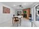 Bright dining room with modern furnishings, brick fireplace, and seamless access to the outdoors at 6339 Coopers Green Ct, Orlando, FL 32819