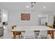 Modern dining room with white tile floors and a large artwork piece on the wall at 6339 Coopers Green Ct, Orlando, FL 32819