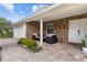 Inviting front porch featuring brick paving, stylish outdoor seating, and beautiful landscaping for relaxing at 6339 Coopers Green Ct, Orlando, FL 32819