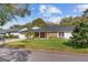 Charming single-story home with a brick facade, well-manicured lawn, and mature trees in a desirable neighborhood at 6339 Coopers Green Ct, Orlando, FL 32819