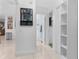 Hallway with white tile floors and access to the bathroom and kitchen at 6339 Coopers Green Ct, Orlando, FL 32819