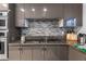Sleek kitchen with stainless steel appliances, granite countertops, and stylish backsplash at 6339 Coopers Green Ct, Orlando, FL 32819
