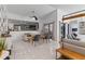 Bright open-concept living room with tile flooring, modern decor, and seamless access to the kitchen at 6339 Coopers Green Ct, Orlando, FL 32819