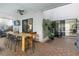 Inviting outdoor patio with a large wooden table, ceiling fan, and sliding glass doors to bring the outdoors in at 6339 Coopers Green Ct, Orlando, FL 32819