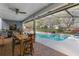 Inviting outdoor patio with a view of the pool, an outdoor bar, and outdoor furniture at 6339 Coopers Green Ct, Orlando, FL 32819