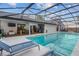 Stunning screened-in pool with clear blue water and an inviting outdoor dining and grill area at 6339 Coopers Green Ct, Orlando, FL 32819