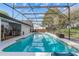 Relaxing screened-in pool with clear blue water, poolside furniture, and well-maintained landscaping at 6339 Coopers Green Ct, Orlando, FL 32819