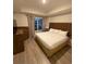 Cozy bedroom showcases a king-size bed, modern headboard, soft lighting, and contemporary decor at 7395 Universal Blvd # 104, Orlando, FL 32819