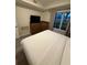 Bright bedroom featuring a comfy bed, wooden furniture, contemporary TV, and natural light at 7395 Universal Blvd # 104, Orlando, FL 32819