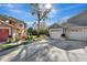 Exterior of a lovely home with attached garages, driveway, landscaping, and well-maintained lawn at 7781 Sugar Bend Dr # 7781, Orlando, FL 32819