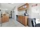 Functional kitchen area with wooden cabinets, tile floors, and granite countertops, offering a practical cooking space at 7781 Sugar Bend Dr # 7781, Orlando, FL 32819