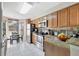 Well-lit eat-in kitchen features granite countertops, stainless steel appliances, and wood cabinets, perfect for cooking and dining at 7781 Sugar Bend Dr # 7781, Orlando, FL 32819