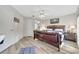 Bright main bedroom with ceiling fan, connecting door to main bath and wood floors, offering comfort and style at 7781 Sugar Bend Dr # 7781, Orlando, FL 32819