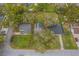 Aerial view shows a home with large yard, mature trees, and street access at 818 Alabama Ave, St Cloud, FL 34769