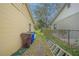 Exterior yard between homes with chain link fence, shed, and minimal grass at 818 Alabama Ave, St Cloud, FL 34769