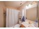Bathroom featuring neutral tile, shower, and a vanity with a bright gold faucet at 818 Alabama Ave, St Cloud, FL 34769