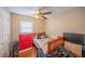 Bright bedroom with ceiling fan, window, and cozy furnishings at 818 Alabama Ave, St Cloud, FL 34769