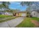 Charming yellow home with well-maintained lawn, brick accents, and convenient driveway access at 818 Alabama Ave, St Cloud, FL 34769