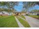 Charming yellow home with well-maintained lawn, brick accents, and convenient driveway access at 818 Alabama Ave, St Cloud, FL 34769
