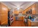 Well-lit kitchen features wood cabinets, stainless appliances, and durable flooring at 818 Alabama Ave, St Cloud, FL 34769