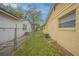Side yard between buildings features grass, fencing, and an air conditioning unit at 818 Alabama Ave, St Cloud, FL 34769