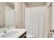 Cozy bathroom with single sink vanity, white shower curtain and neutral wall color at 8321 Bryce Canyon Ave, Windermere, FL 34786